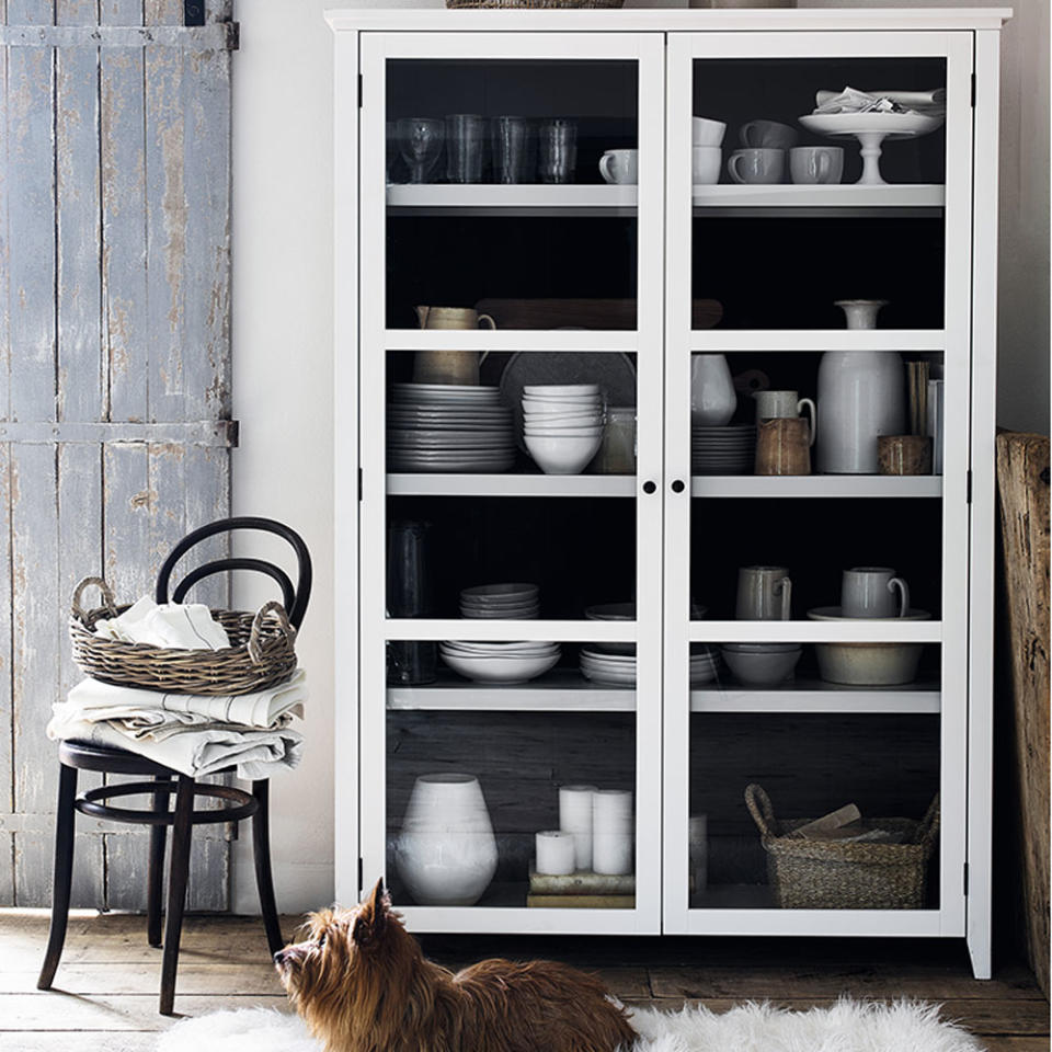 Dining room with family dog lying in front of a white glass display cabinet