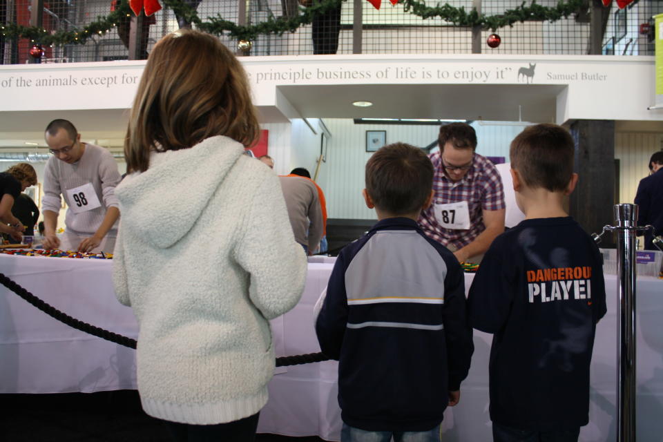 Children watch in awe as Dave Camplin starts building.