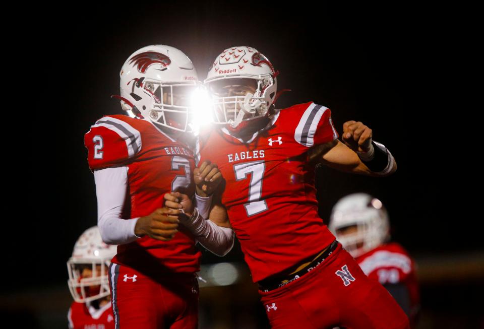 Nixa's Randy Flint (2) and Parker Mann celebrate after a fumble recovery on the Joplin Eagles in the championship game of Class 6 District 5 football at Nixa on Friday, Nov. 11, 2023.