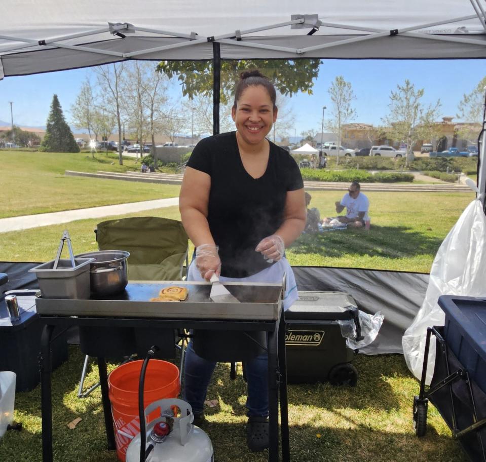 Amber Bobo prepares a tasty Roll Me Up Cinnamon Roll at the Hesperia Community Farmers Market.