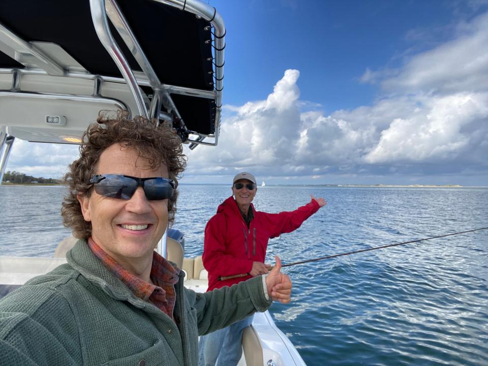 Authors Adam Gamble, foreground, and Michael Tougias, aboard the Scout on one of the many fishing trips that spawned their new book, "The Power of Positive Fishing."
