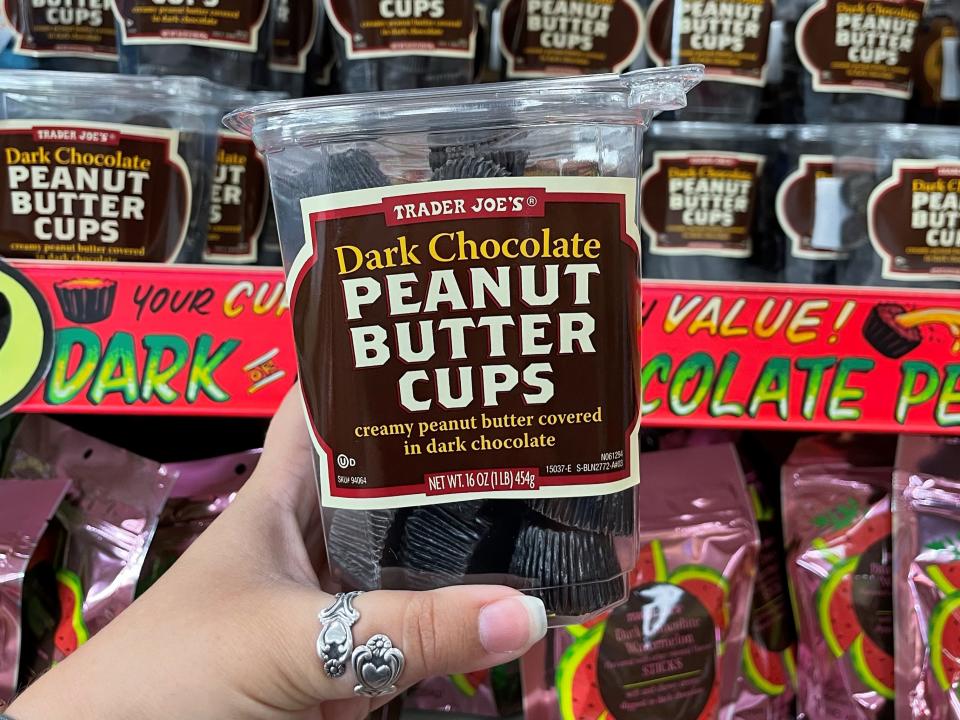 trader joe's dark-chocolate peanut butter cups in author's hand in front of display