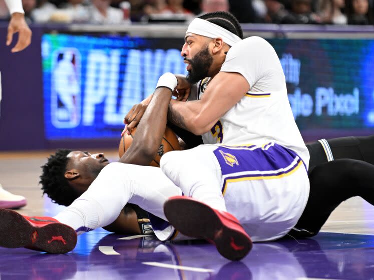 Los Angeles, California April 22, 2023-Lakers Anthony Davis battles or a loose ball with Grizzlies Jaren Jackson Jr.