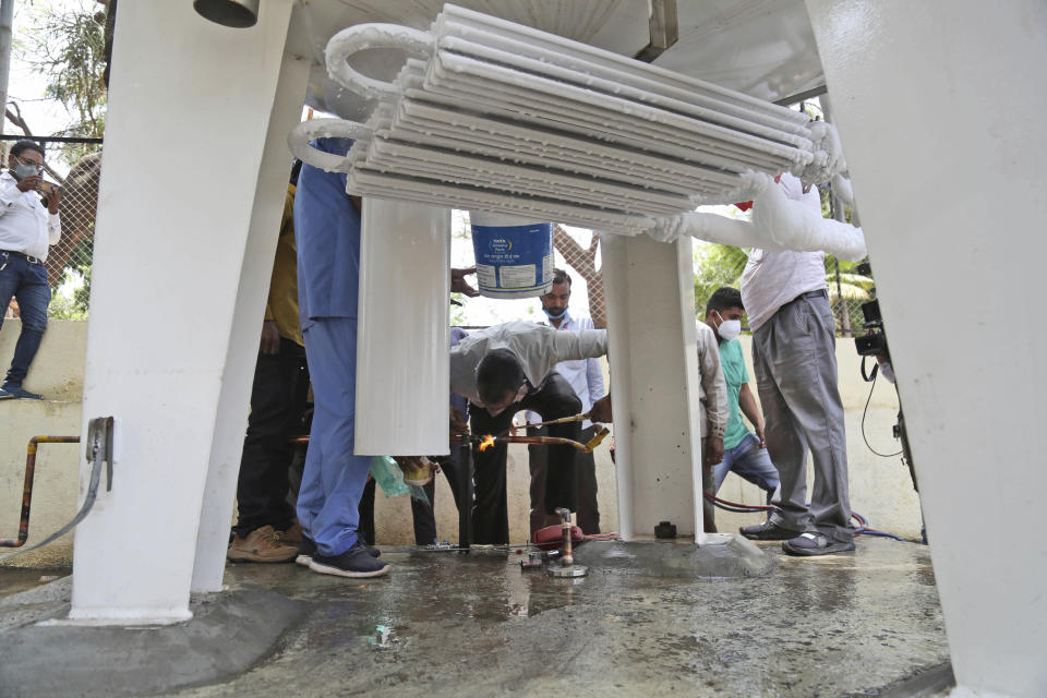 Hospital staff fix a leakage in their oxygen plant in Nashik, in the Indian state of Maharashtra, Wednesday, April 21, 2021. A local administrator in western India says 22 patients have died in a hospital when their oxygen supply was interrupted by a leakage in a supply tank. The official says the oxygen supply has since been resumed to other patients. (AP Photo)