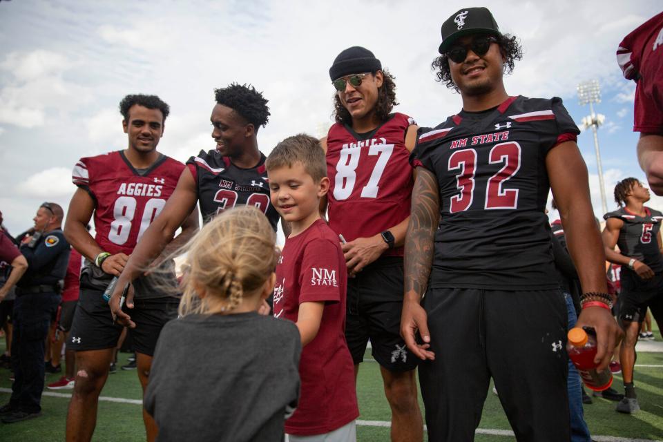 Aggie football players greet fans during NMSU's homecoming celebration  on Saturday, Oct. 22, 2022, at the Aggie Memorial Stadium. The football game was postponed after a player on the opposing team was killed in a traffic crash.