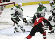 Ottawa Senators left wing Brady Tkachuk (7) scores past Dallas Stars defenseman Miro Heiskanen (4) and goaltender Anton Khudobin (35) during the first period of an NHL hockey game Sunday, Feb. 16, 2020, in Ottawa, Ontario. (Justin Tang/The Canadian Press via AP)