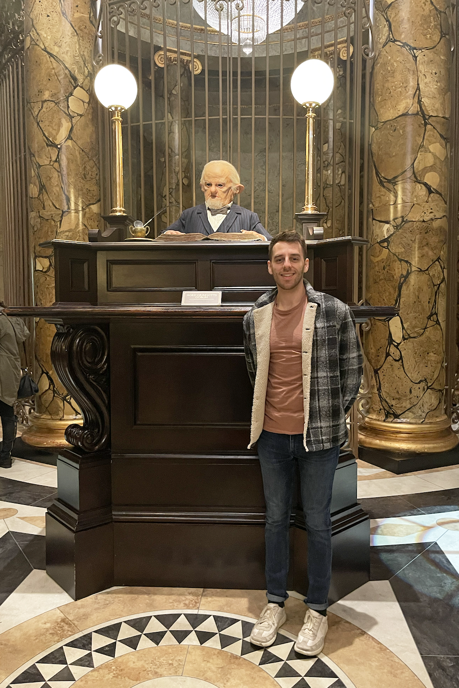 Person posing with a lifelike figure of Abraham Lincoln at a historical exhibit