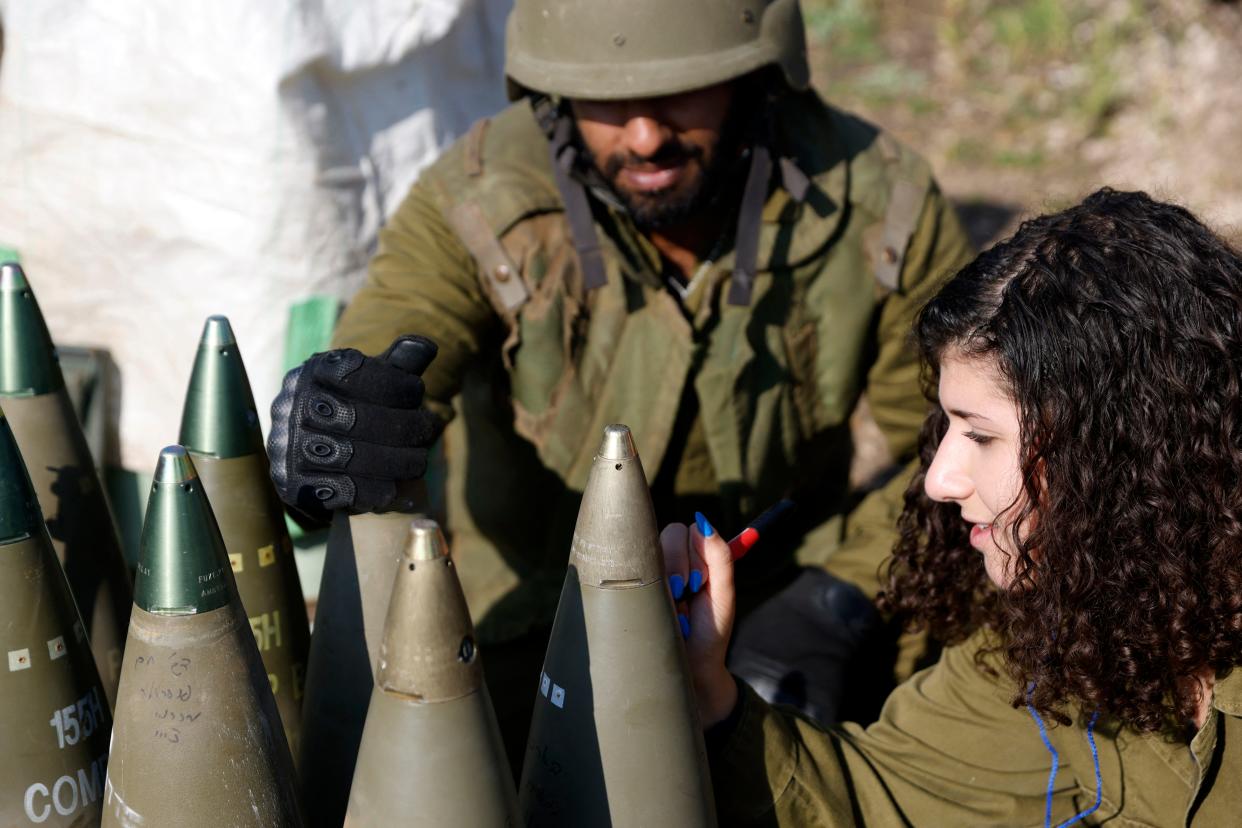 An Israeli soldier signs a bomb in the Upper Galilee in northern Israel as an artillery unit shells southern Lebanon on Jan. 4, 2024. Lebanon's Hezbollah leader Hassan Nasrallah warned Israel against all-out conflict after Israeli army chief Herzi Halevi, in a visit to the Lebanese border, said troops were "in very high readiness."