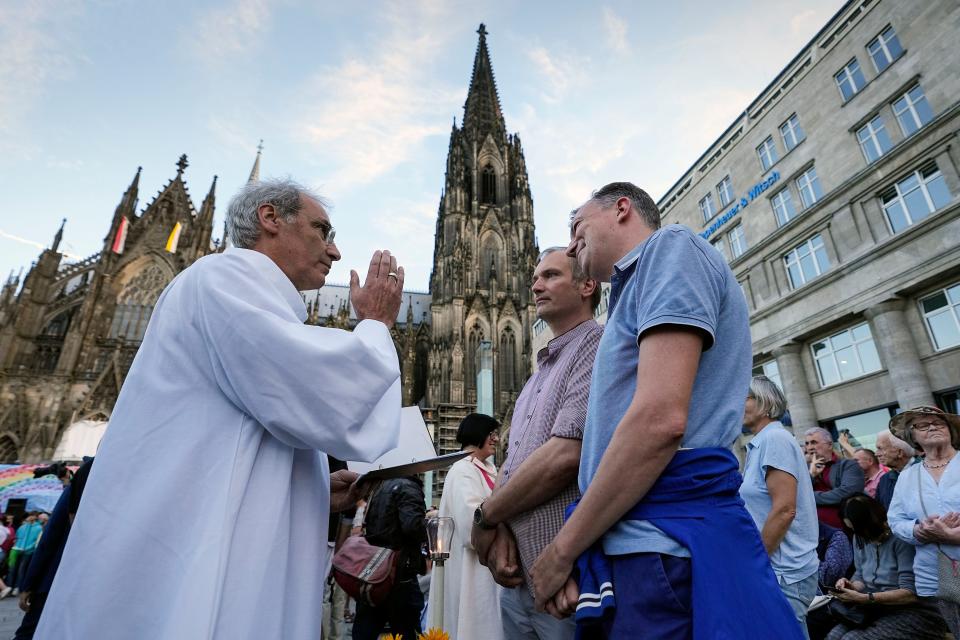 Same-sex couples take part in a public blessing ceremony in front of the Cologne Cathedral in Cologne, Germany, on Sept. 20, 2023. Pope Francis has formally approved allowing priests to bless same-sex couples, with a new document released Monday Dec. 18, 2023 explaining a radical change in Vatican policy by insisting that people seeking God’s love and mercy shouldn’t be subject to “an exhaustive moral analysis” to receive it.