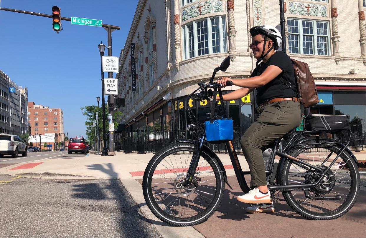 Norah Alwalan rides her e-bike from the Michiana Bike to Work breakfast on June 14, 2022, at Jon Hunt Plaza to her job at the St. Joe County Public Library in downtown South Bend.