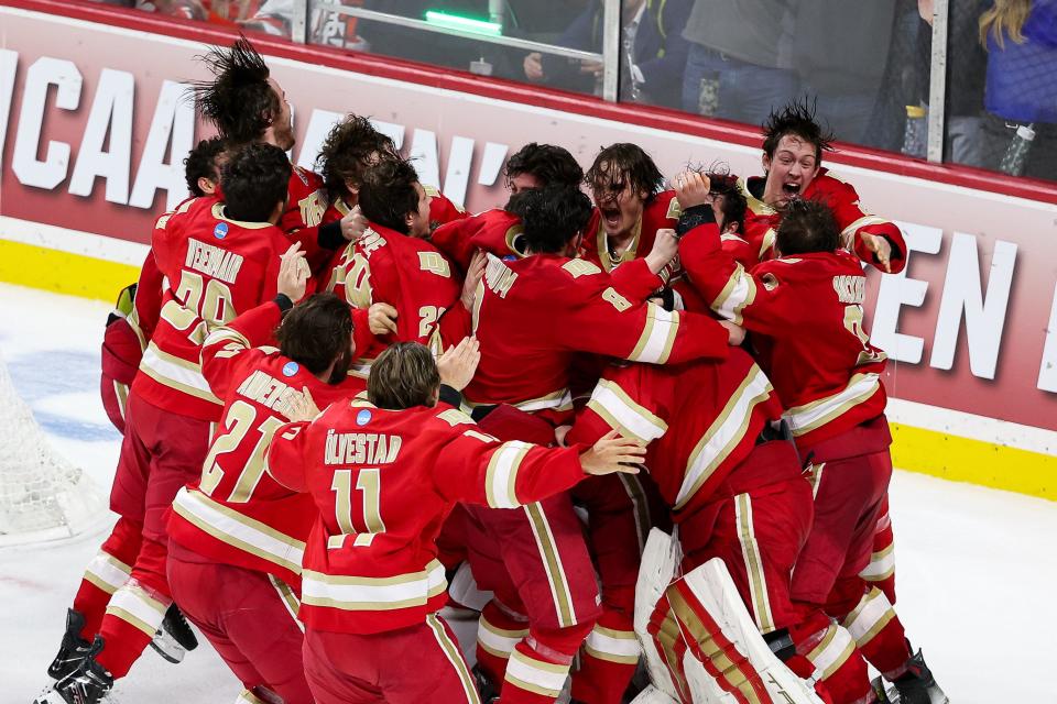 Denver players celebrate after beating Boston College in the championship game of the 2024 Frozen Four college hockey tournament.