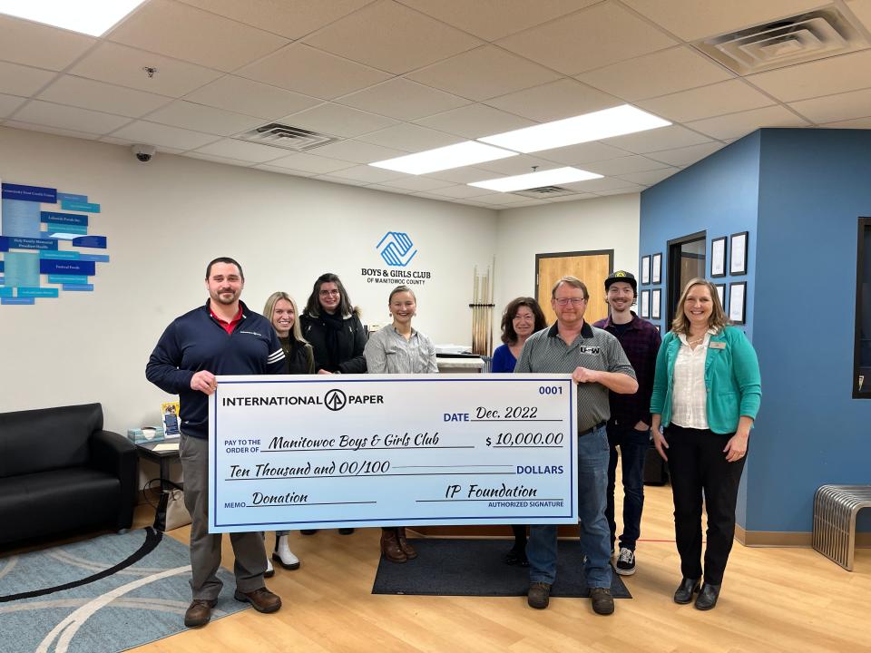 Boys & Girls Club of Manitowoc County accepts a check representing a $10,000 grant from the International Paper Foundation.