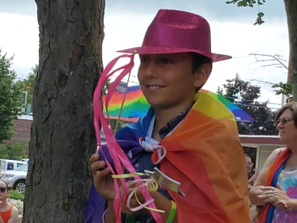 Elias Buchakjian-Tweedy, 10, son of Pastor Eliza Tweedy of First Church Congregational in Rochester watches proudly as his mom speaks at Rochester Pride on Saturday.