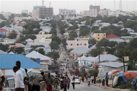 People walk along a street in Mogadishu September 28, 2013. REUTERS/Feisal Omar