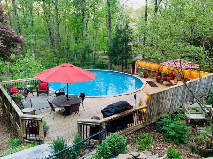 View outdoor patio with circular pool on wooded estate in Charlotte, NC, Courtenay Rudzinski airbnb review