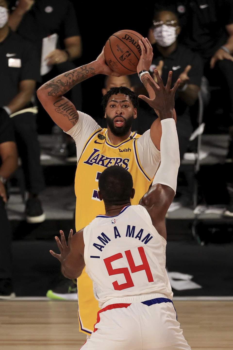 Los Angeles Lakers' Anthony Davis, top, looks to pass against Los Angeles Clippers' Patrick Patterson (54) during the third quarter oof an NBA basketball game Thursday, July 30, 2020, in Lake Buena Vista, Fla. (Mike Ehrmann/Pool Photo via AP)