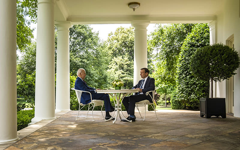 President Biden meets with Sen. Chris Murphy at a table outside the Oval Office