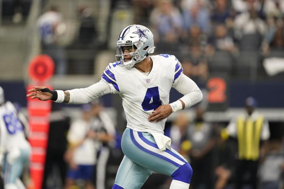 Dallas Cowboys quarterback Dak Prescott hands the ball off.