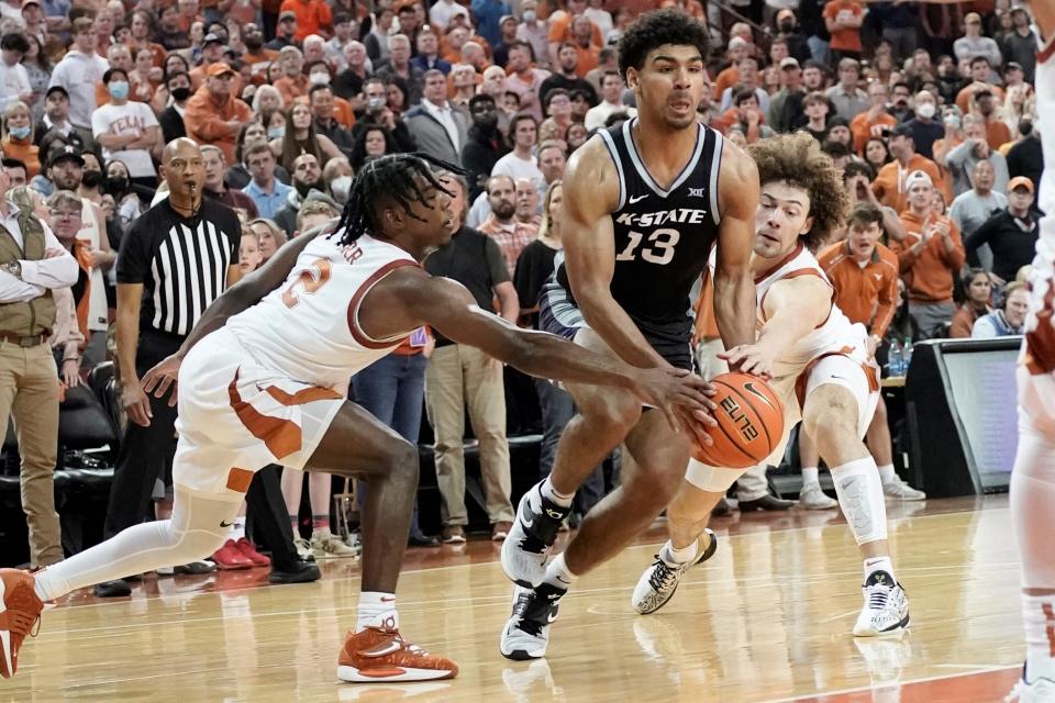 Kansas State guard Mark Smith (13) drives to the basket between Texas' Marcus Carr (2) and Devin Askew (5) during the second half Tuesday night at Frank Erwin Center. Smith finished with 22 points and eight rebounds in the Wildcats' 66-65 victory.