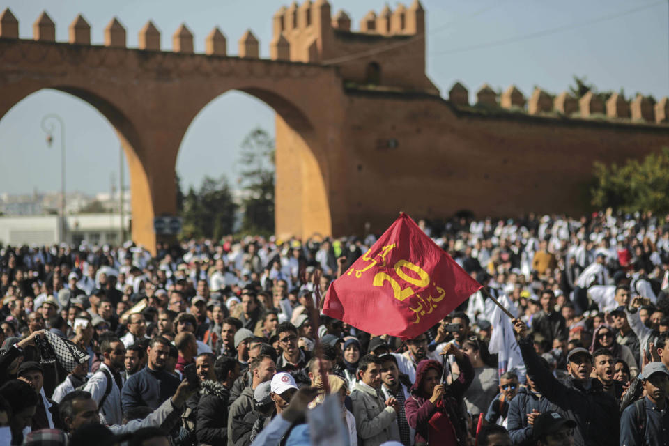 Teachers wave a flag commemorating the Feb. 20 Moroccan Arab Spring movement, during a a demonstration in Rabat, Morocco, Wednesday, Feb. 20, 2019. Moroccan police fired water cannons at protesting teachers who were marching toward a royal palace and beat people with truncheons amid demonstrations around the capital Wednesday. Several demonstrations were held Wednesday, marking exactly eight years after the birth of a Moroccan Arab Spring protest movement that awakened a spirit of activism in this North African kingdom. (AP Photo/Mosa'ab Elshamy)