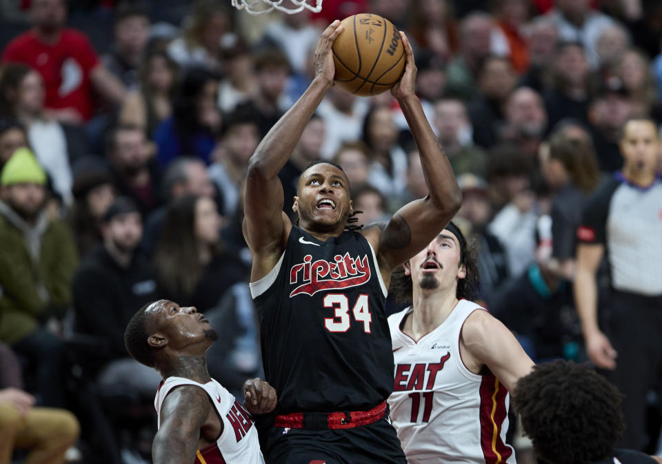 Portland Trail Blazers forward Jabari Walker, center, shoots between Miami Heat guard Terry Rozier, left, and guard Jaime Jaquez Jr. during the second half of an NBA basketball game in Portland, Ore., Tuesday, Feb. 27, 2024. (AP Photo/Craig Mitchelldyer)