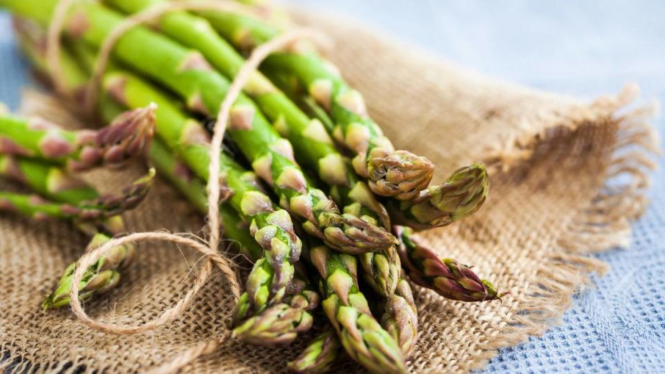 Raw fresh asparagus on rustic background, close-up