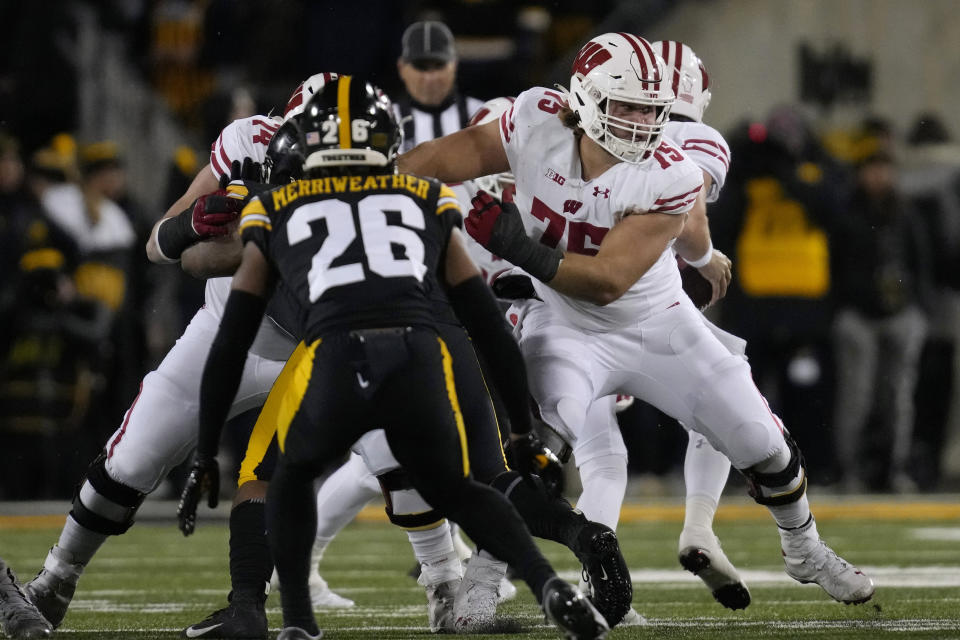 FILE - Wisconsin offensive lineman Joe Tippmann looks to make a block during the team's NCAA college football game against Iowa, Nov. 12, 2022, in Iowa City, Iowa. The New York Jets selected Tippmann in the second round of the NFL draft Friday night, April 28. Tippmann, the 43rd overall pick, helps bolster an offensive line that will be protecting recently acquired quarterback Aaron Rodgers this season. (AP Photo/Charlie Neibergall, File)