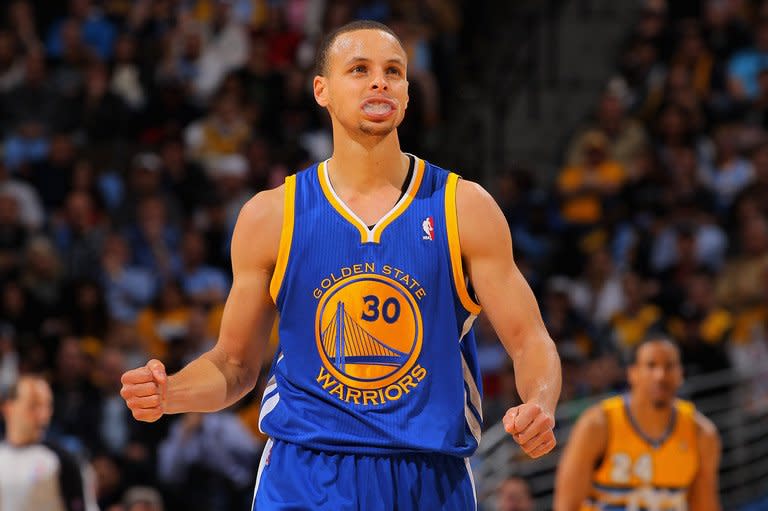 Stephen Curry of the Golden State Warriors celebrates a play against the Denver Nuggets on April 23, 2013. Curry scored 30 points and added 13 assists to power the hot-shooting Warriors over the Nuggets 131-117