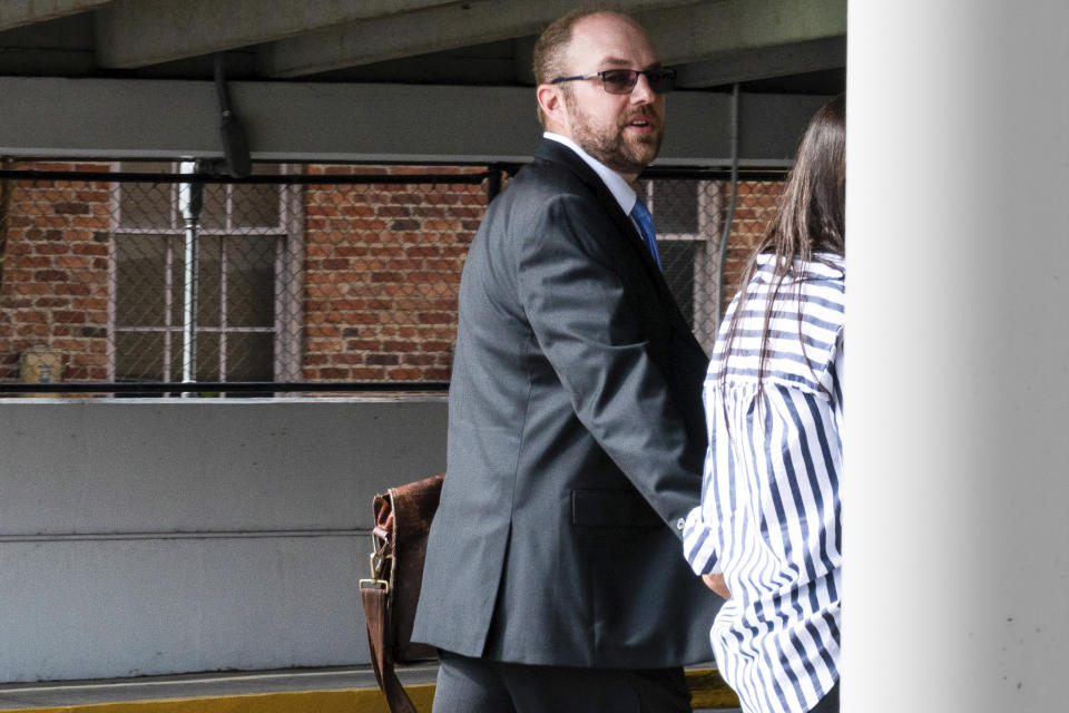 Patrick Parker Walsh, left, heads to his car with his wife in Gainesville, Fla. on Tuesday, Jan. 31, 2023, after he was sentenced to five and a half years in federal prison for stealing nearly $8 million in federal COVID-19 relief funds. He surrendered himself for imprisonment at a later date. (Augustus Hoff/WUFT News via AP)