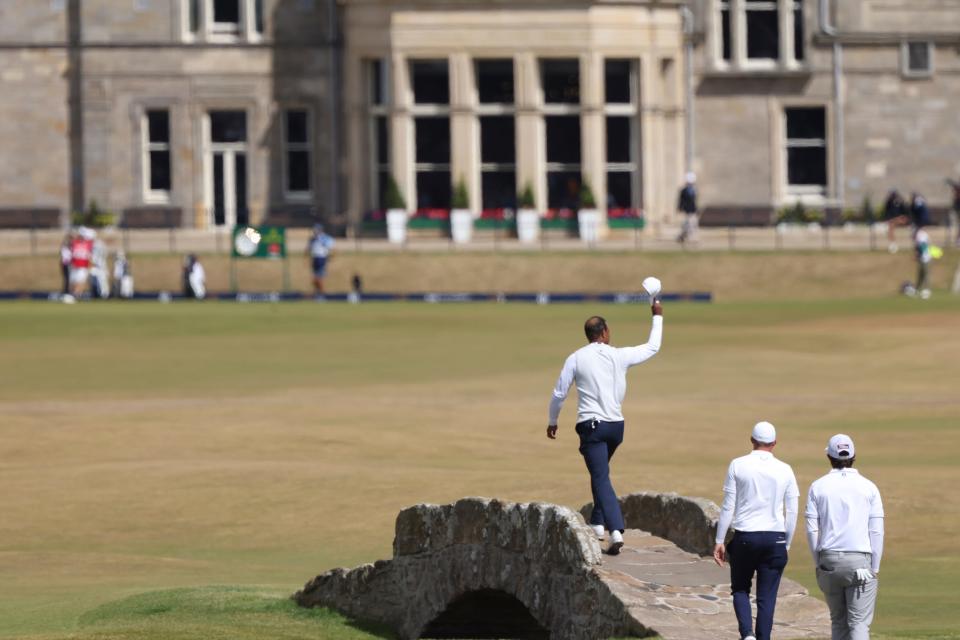 Tiger Woods of the US gestures to the crowd at the end of his second round of the British Open golf championship on the Old Course at St. Andrews, Scotland, Friday July 15, 2022. The Open Championship returns to the home of golf on July 14-17, 2022, to celebrate the 150th edition of the sport's oldest championship, which dates to 1860 and was first played at St. Andrews in 1873. (AP Photo/Peter Morrison)