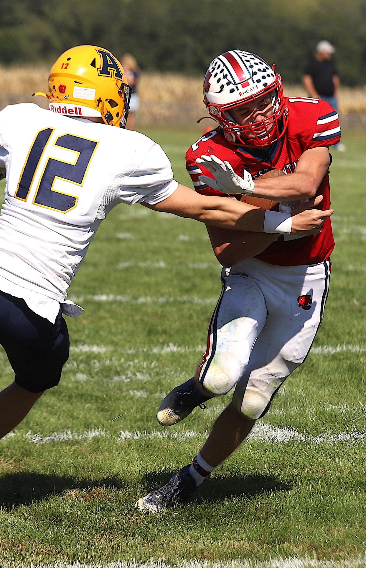 West Central’s Kaiden Droste (12) runs against Aquin’s Brayden Jackson (12) earlier this season. Droste is expected to be a key player as the top ranked Heat face No. 2 Amboy on Friday.