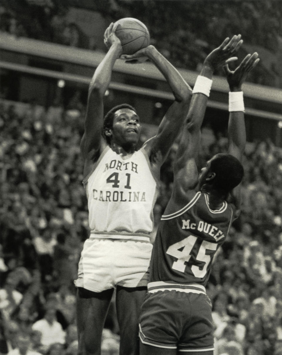 North Carolina Tar Heels forward Sam Perkins (41) shoots the ball against the North Carolina State Wolfpack center Cozell McQueen (45). Malcolm Emmons- USA TODAY Sports