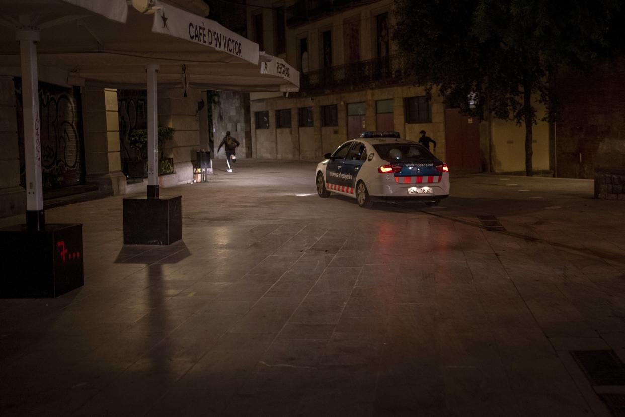 People run away from police chasing them after curfew in Barcelona, Spain on Sunday, Nov. 1, 2020. At the strike of 10:00 p.m., crime fighters become party poopers in Barcelona. Police officers fan out across the Spanish city each night to stamp out clandestine parties that are prime contagion sources now that a nationwide curfew has shut down bars and nightclubs.