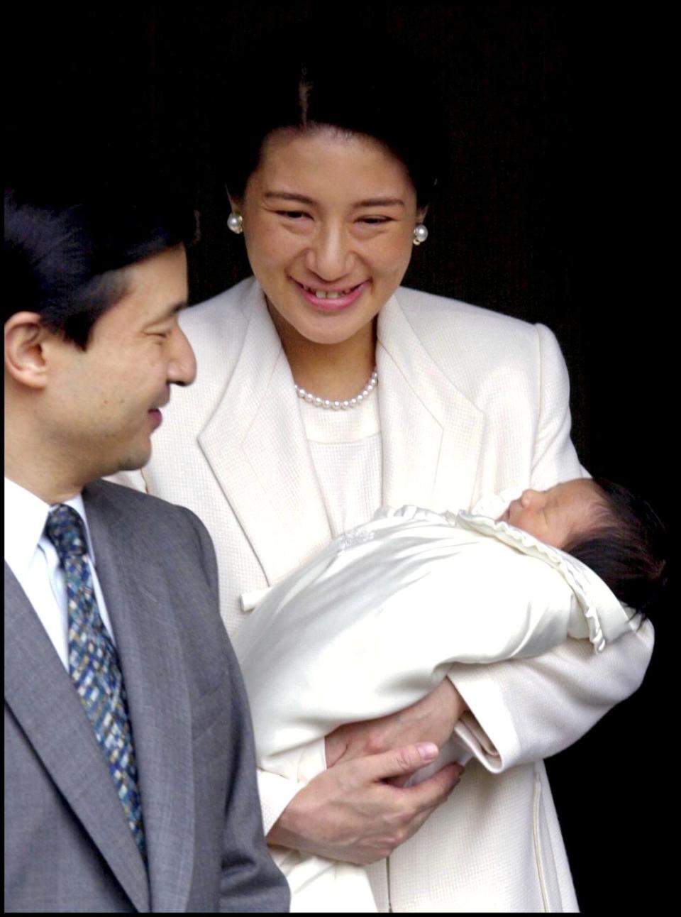 crown prince naruhito and crown princess masako as the royal couple leaves the imperial hospital with their infant daughter princess aiko in tokyo, japan on december 08, 2001