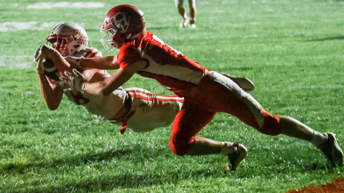 Weiser’s Brock Spencer dives for a touchdown catch in front of Homedale’s Mason Strong last season.