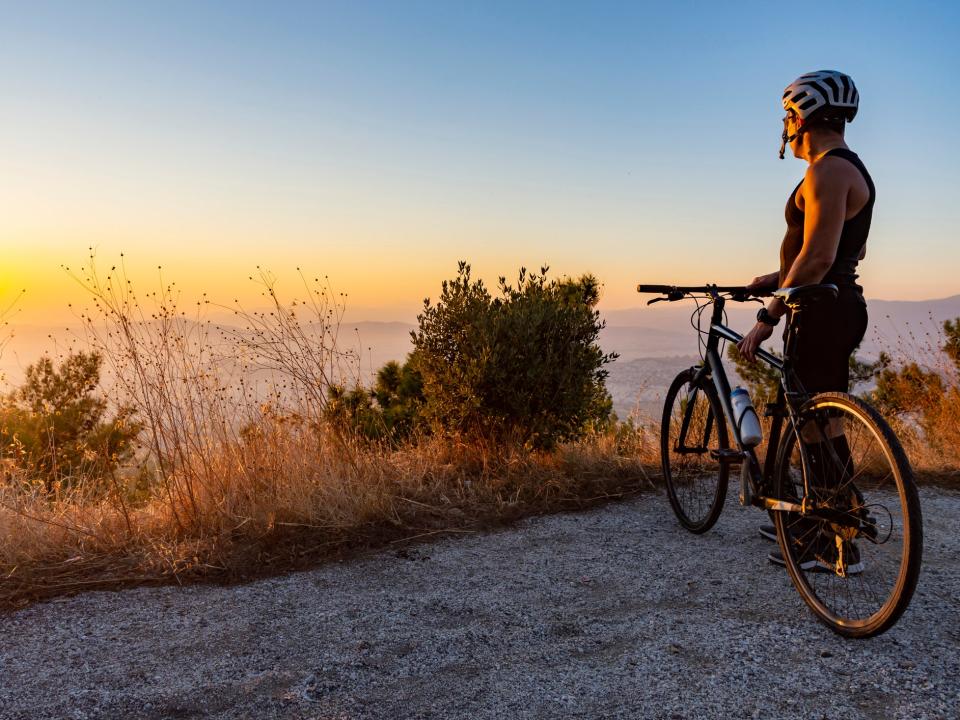 A cyclist watches the sun set in Greece: istock