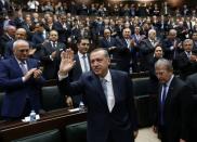 <p>Turkey’s Prime Minister Tayyip Erdogan greets his supporters as he arrives for a meeting at the Turkish parliament in Ankara February 25, 2014. Erdogan said on Tuesday voice recordings purportedly of him telling his son to dispose of large sums of money on the day news broke of a graft inquiry were a “treacherous attack” on his office. (Umit Bektas/Reuters) </p>