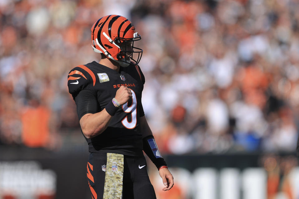 Cincinnati Bengals quarterback Joe Burrow (9) reacts after a Bengals touchdown by Joe Mixon during the first half of an NFL football game against the Cleveland Browns, Sunday, Nov. 7, 2021, in Cincinnati. (AP Photo/Aaron Doster)