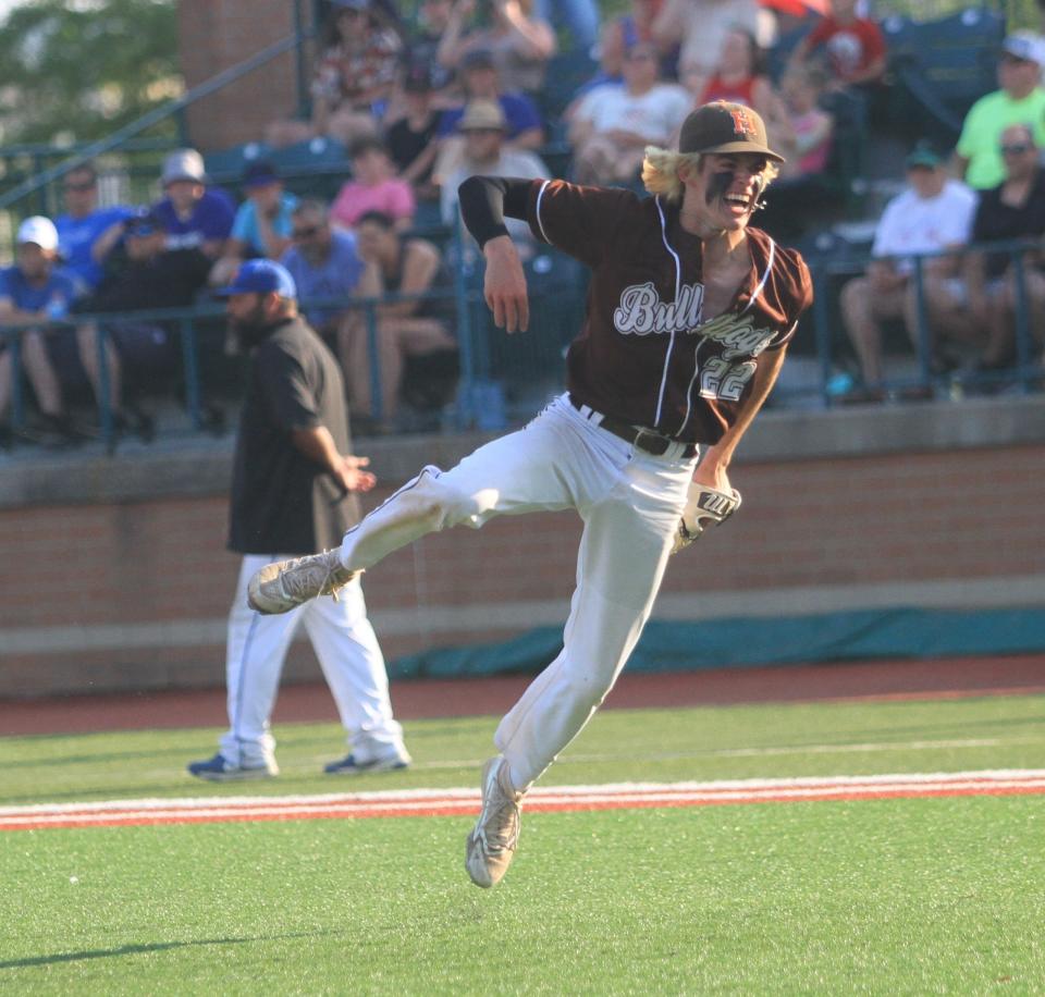 Heath's Riley Baum celebrates an inning-ending double play during the Bulldogs' 6-2 victory over Greeneview in a Division III regional final on Friday,