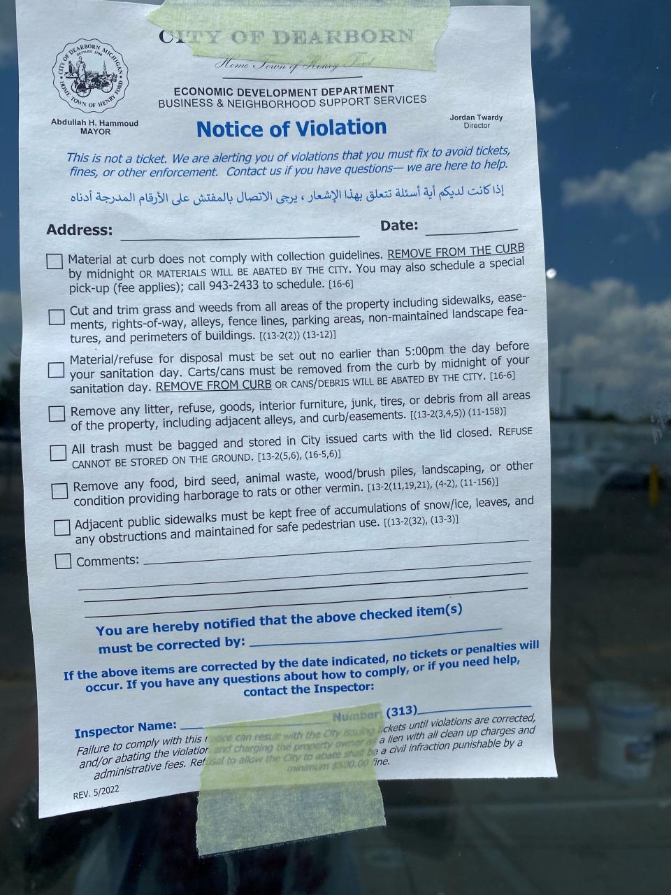 A violation notice posted on the front of an empty Kroger in Dearborn that was expected to become an Amazon Fresh grocery store.