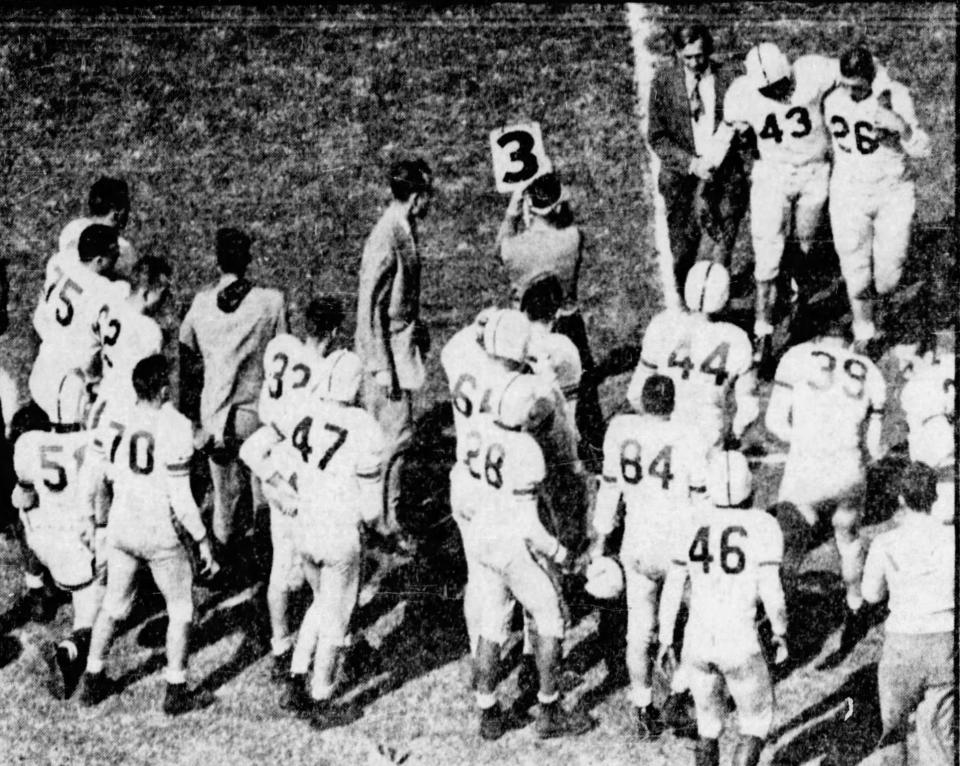 From Oct. 21, 1951: Johnny Bright (43), Drake University's star halfback, is led off the field at Stillwater, Oklahoma, with his jaw broken in the game against Oklahoma A&M. Trainer Ben Mankowski, left, and guard Jack Humm (26) help Bright off the field. 