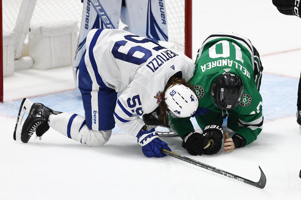 Toronto Maple Leafs forward Tyler Bertuzzi (59) checks on Dallas Stars forward Ty Dellandrea (10) after inadvertently hitting him in the face with the puck during the third period of an NHL hockey game, Thursday, Oct. 26, 2023, in Dallas. Dellandrea would leave the game, no penalty was called. Toronto won 4-1. (AP Photo/Brandon Wade)