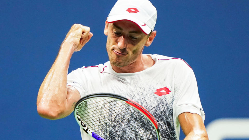 John Millman reacts after winning the second set against Roger Federer. (Photo by EDUARDO MUNOZ ALVAREZ / AFP)