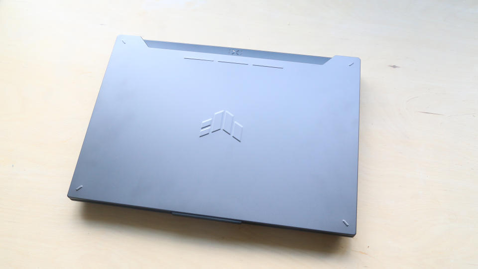 Asus Tuf Gaming F15 laptop on a wooden surface