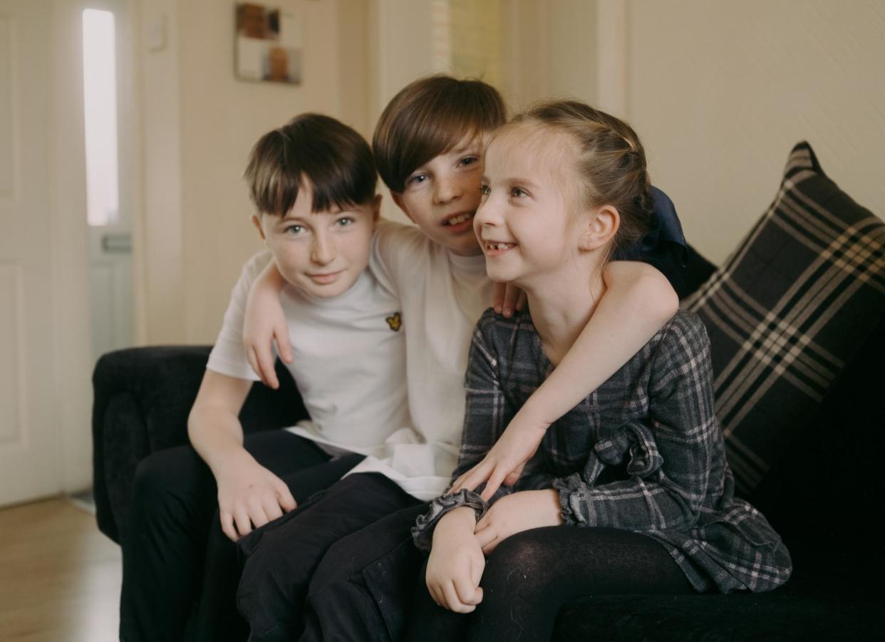 <span>Leanne’s* two sons - Nathan* and Logan* , age 11 and eight, and her daughter, Faith*, six, at their grandma’s home in Tameside.</span><span>Photograph: Dan Dennison</span>