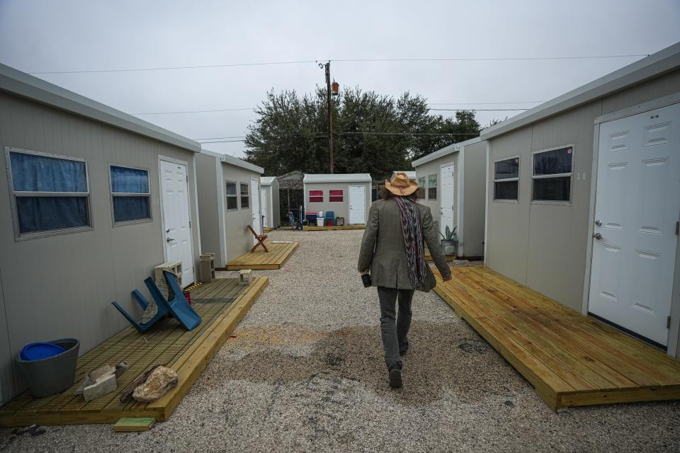 Donald "Hippie" Montgomery walks to his cabin in the Esperanza community. “I love it here, and after all this and all they’ve done, I am ready to get back out there,” Montgomery said.