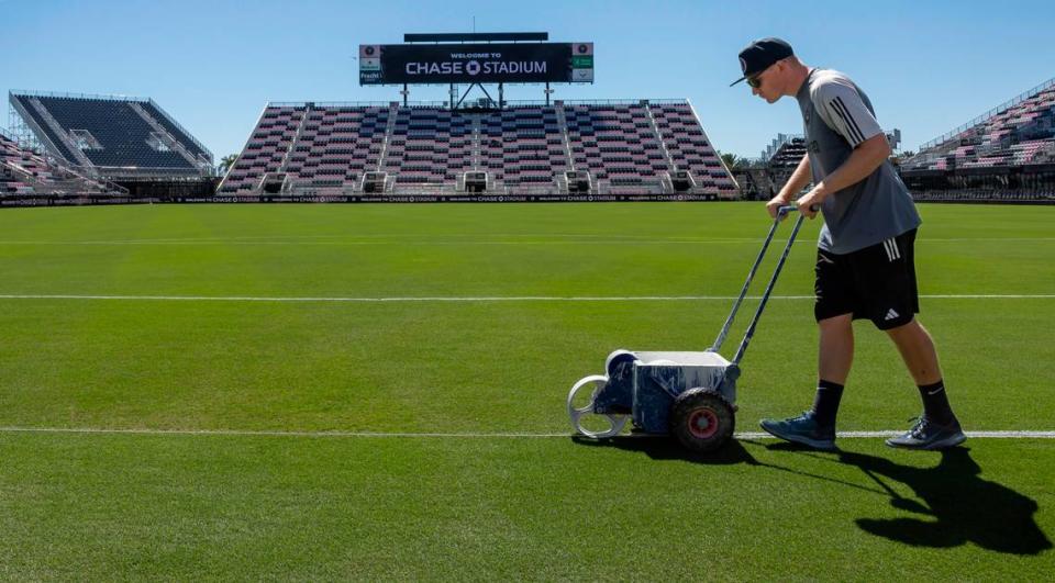 A staff member paints the field before the start of Inter Miami’s MLS season opener against Real Salt Lake at Chase Stadium on Tuesday, Feb. 20, 2024, in Fort Lauderdale, Fla.