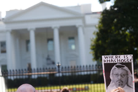 An activist holds an image of missing Saudi journalist Jamal Khashoggi during a demonstration calling for sanctions against Saudi Arabia and to protest Khashoggi's disappearance, outside the White House in Washington, U.S., October 19, 2018. REUTERS/Leah Millis/Files