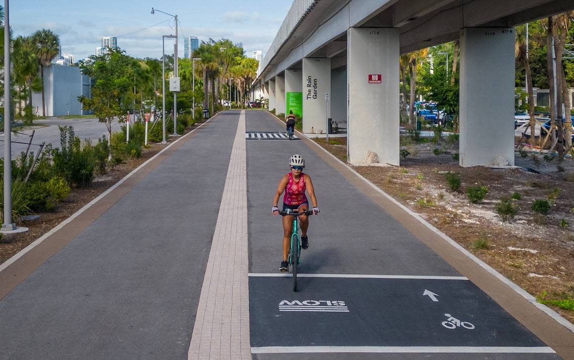 Cyclists ride past the Rain Garden at Southwest 17th Avenue and U.S. 1 along a new, two-mile section of The Underline urban trail and linear park that opens April 24.