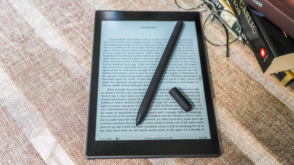 The Onyx Boox Tab Mini C's stylus lying across the display showing grayscale text